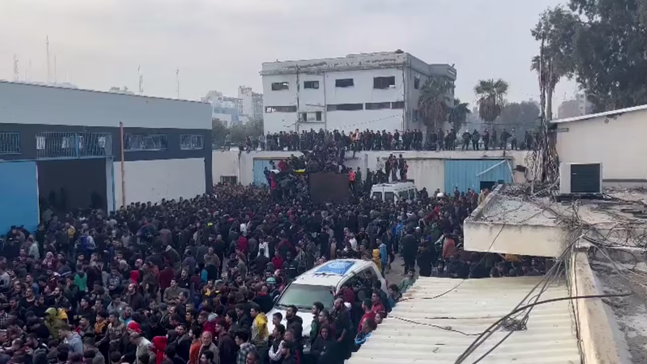 Palestinians swarm a relief aid convoy at a United Nations center in the Al-Zeitoun neighborhood of northern Gaza on Thursday.