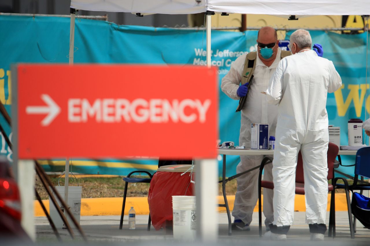 Medical personnel talk at a drive-thru Covid-19 testing station at West Jefferson Medical Center in New Orleans, Louisiana, on March 17.