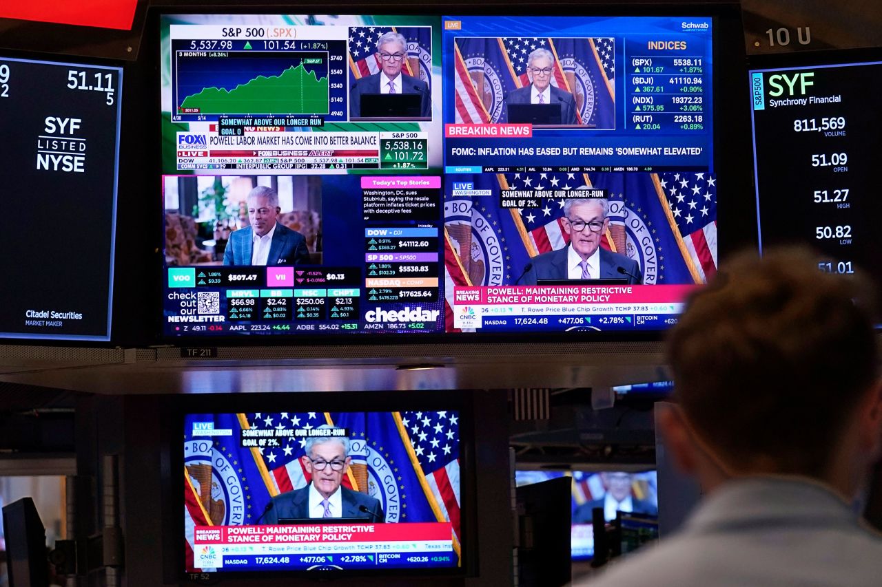 A bank of television screens on the floor of the New York Stock Exchange shows Federal Reserve Chairman Jerome Powell on July 31. 