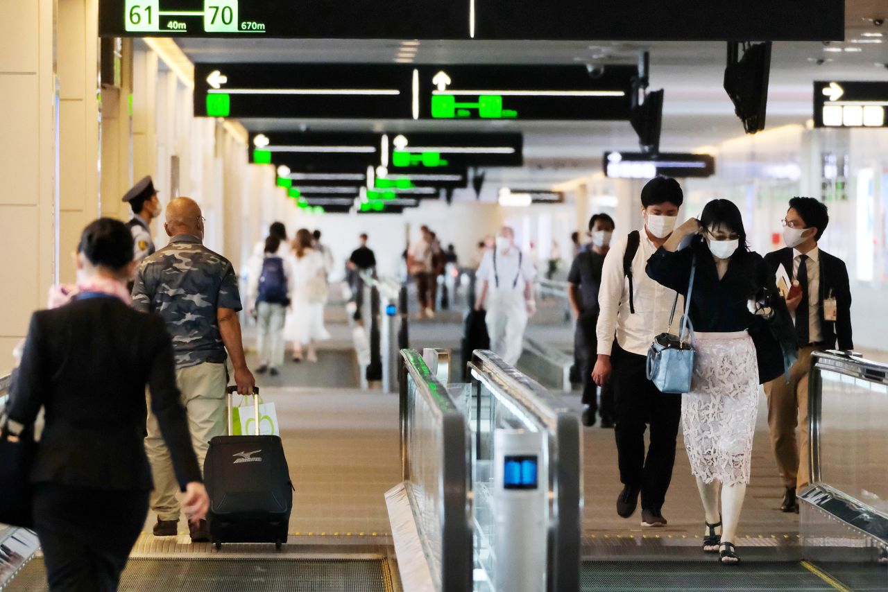 Passengers head to their departure gates at the domestic terminal of Tokyo's Haneda airport in Japan, on July 25. 