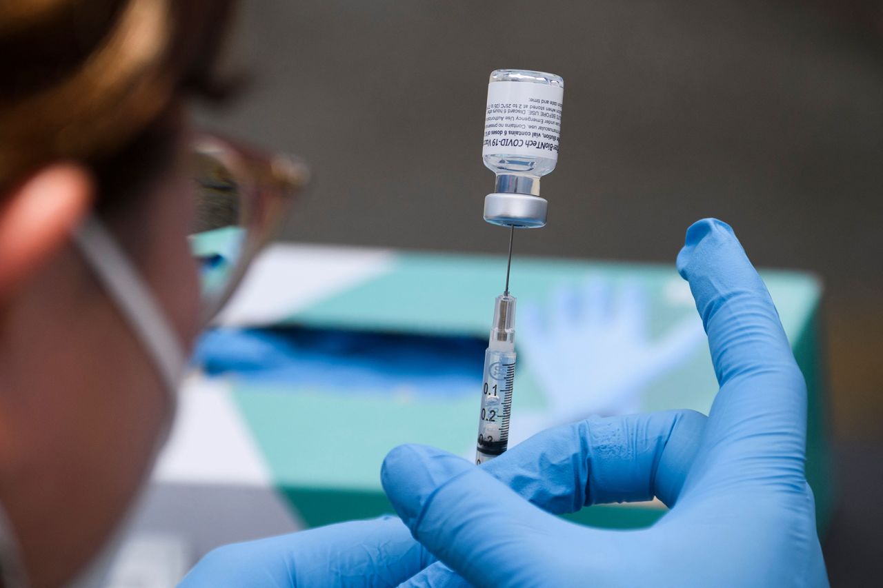 A syringe is filled with a first dose of the Pfizer Covid-19 vaccine at a mobile vaccination clinic during a back to school event offering school supplies, Covid-19 vaccinations, face masks, and other resources for children and their families at the Weingart East Los Angeles YMCA in Los Angeles, California on August 7, 2021.