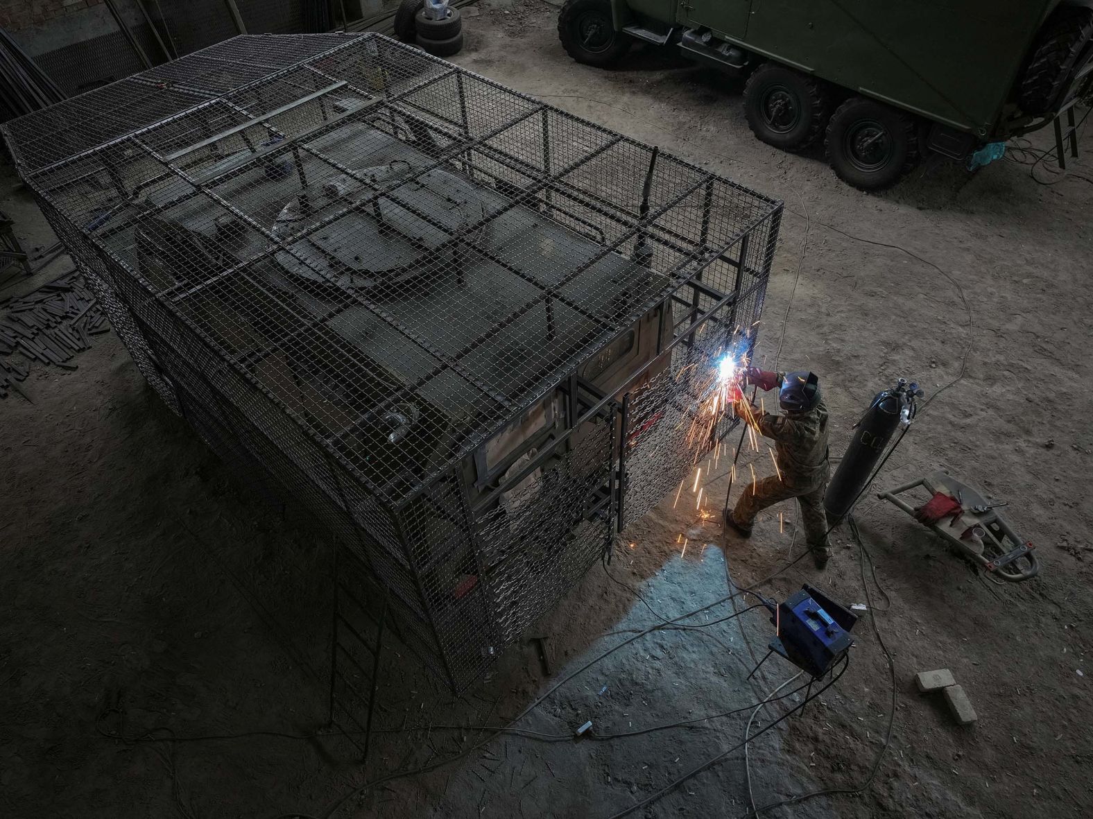 A Ukrainian service member installs protective fencing around a military vehicle captured from Russian troops, while working in Ukraine’s Kharkiv region on Friday, August 1.