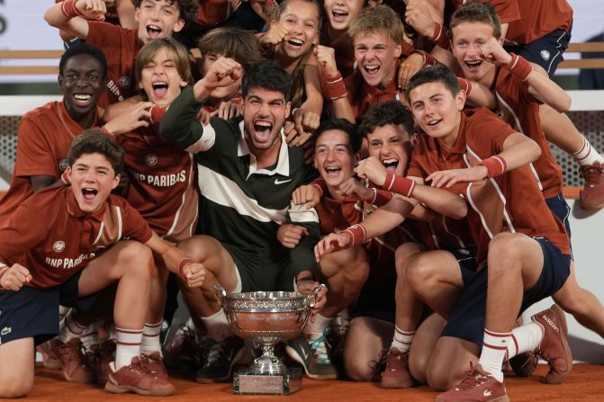Carlos Alcaraz celebrates with ball boys and girls after <a  target="_top" href="/newspapers?url=https://www.cnn.com/2025/06/08/sport/carlos-alcaraz-jannik-sinner-french-open-final-spt">winning the French Open final</a> on Sunday, June 8. The Spaniard mounted an extraordinary comeback to defeat world No. 1 Jannik Sinner 4-6, 6-7 (4), 6-4, 7-6 (3), 7-6 (2). It was the longest final in tournament history.