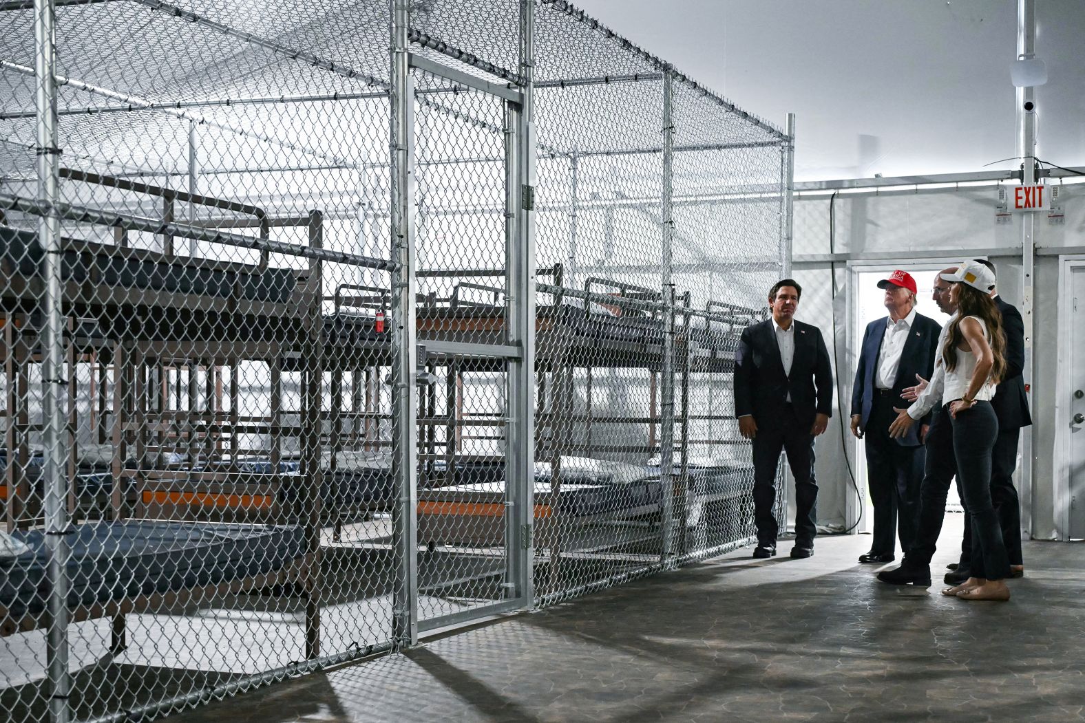 Florida Gov. Ron DeSantis, left, joins President Donald Trump, second from left, and Secretary of Homeland Security Kristi Noem, right, on a tour of a migrant detention facility, dubbed <a href="index.php?page=&url=https%3A%2F%2Fwww.cnn.com%2F2025%2F06%2F24%2Fus%2Falligator-alcatraz-florida-everglades-migrant-detention-hnk">“Alligator Alcatraz,”</a> in Ochopee, Florida, on Tuesday, July 1. The detention, processing and deportation camp for undocumented migrants is situated in Florida’s Everglades, the vast expanse of marshes and swamps that covers much of the southern part of the state.