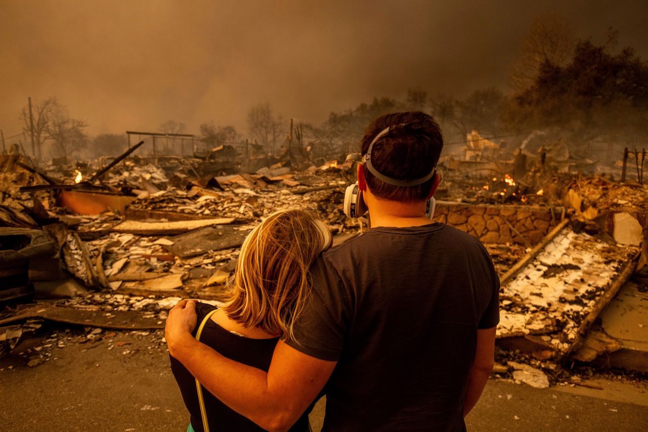 Megan Mantia, left, and her boyfriend Thomas, return to Mantia's fire-damaged home after the Eaton Fire swept through in Altadena, California, on January 8.