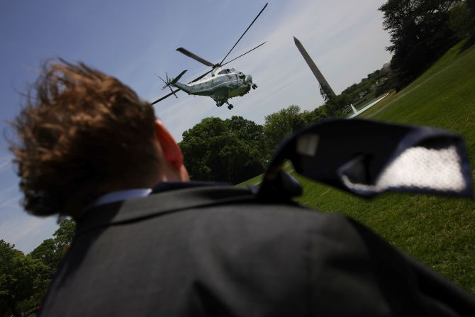 A media member’s necktie blows in the wind as Marine One lifts off from the South Lawn of the White House in Washington, DC, on Tuesday, April 29.