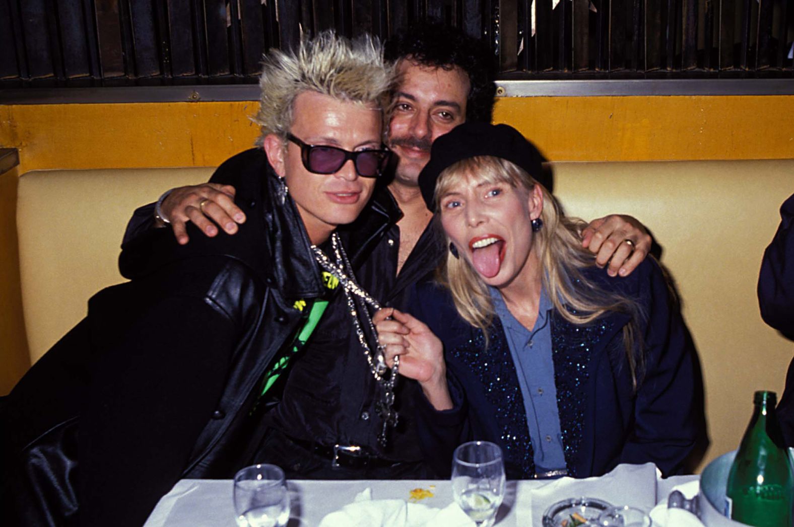 Mitchell attends a party in Los Angeles with singer Billy Idol, left, and her husband Larry Klein in 1991.