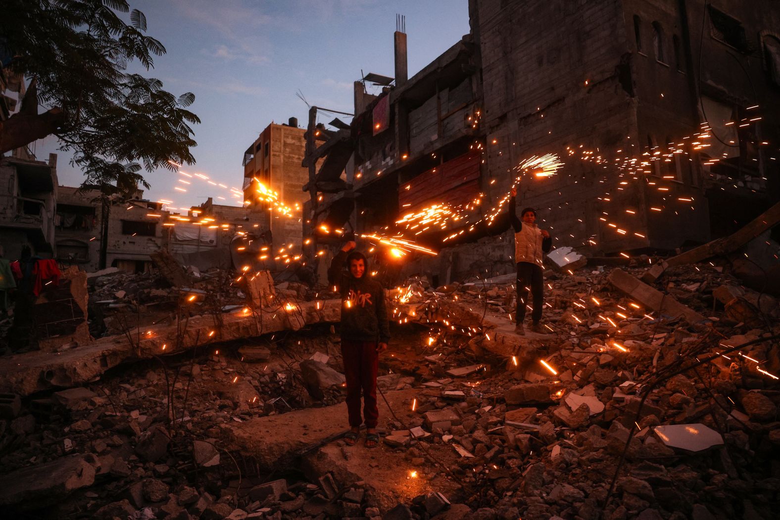 Children play with fireworks at the Bureij camp for displaced Palestinians in Gaza on Monday, December 30.