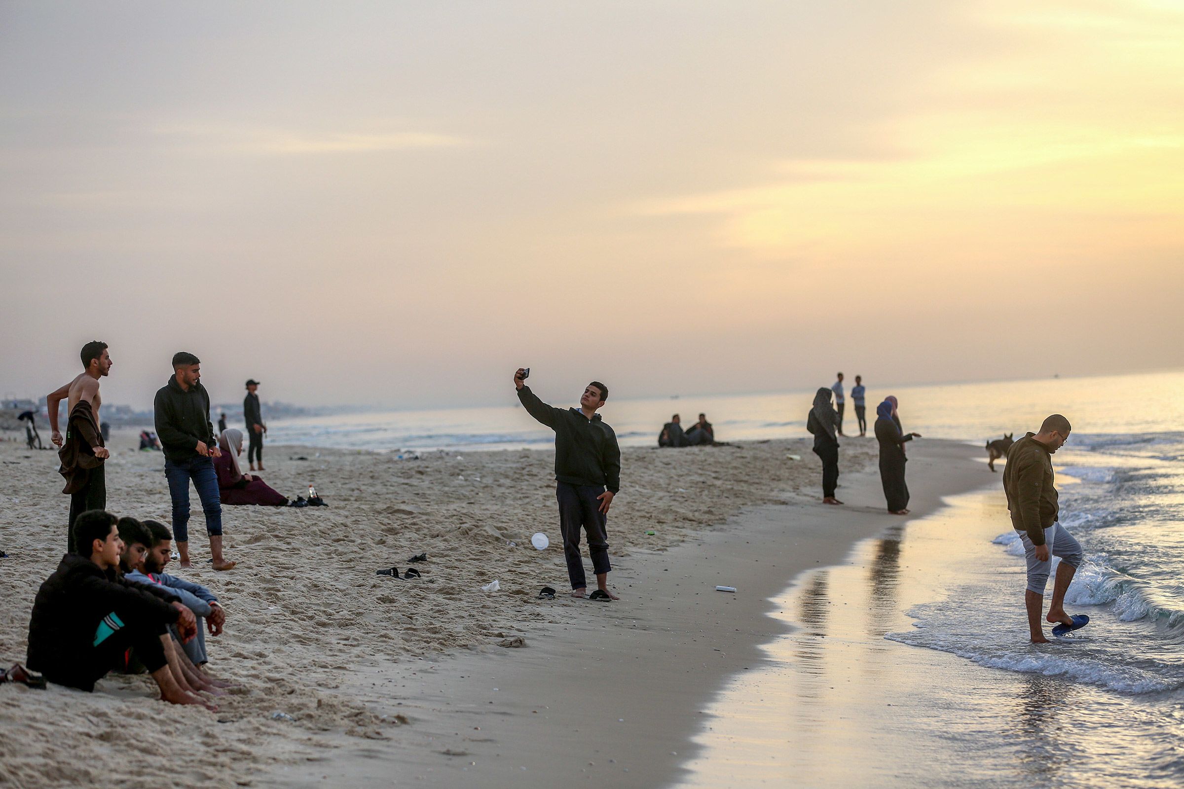 Palestinians enjoy the beach in Khan Younis, Gaza, during the temporary truce on November 25.