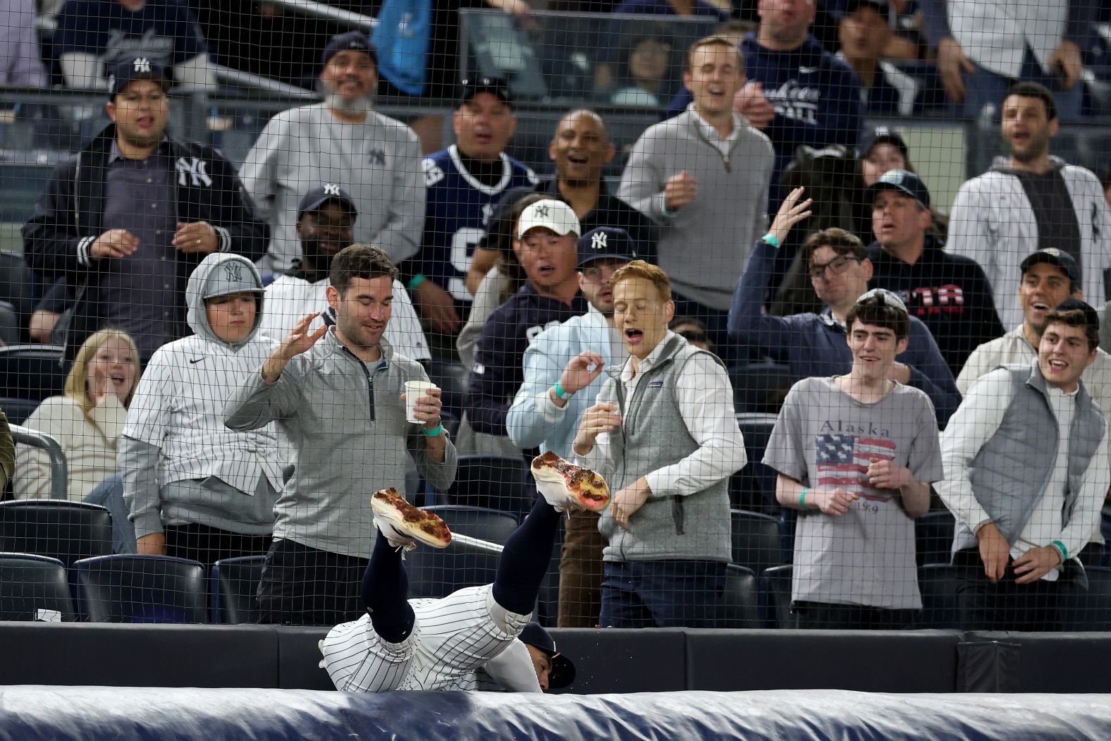 New York Yankees third baseman Oswald Peraza falls over a tarp as he catches a foul ball during a Major League Baseball game against the Texas Rangers on Tuesday, May 20.