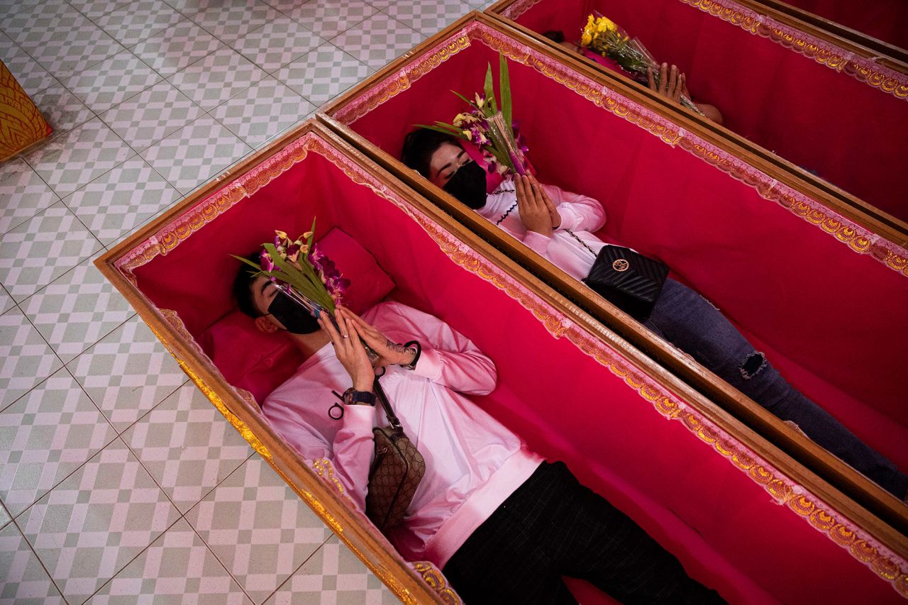 People in Bangkok, Thailand, lay down in coffins during a resurrection ceremony on New Year's Eve. The belief is that the worshippers will be cleansed of bad karma and blessed with good fortune and health in the new year.