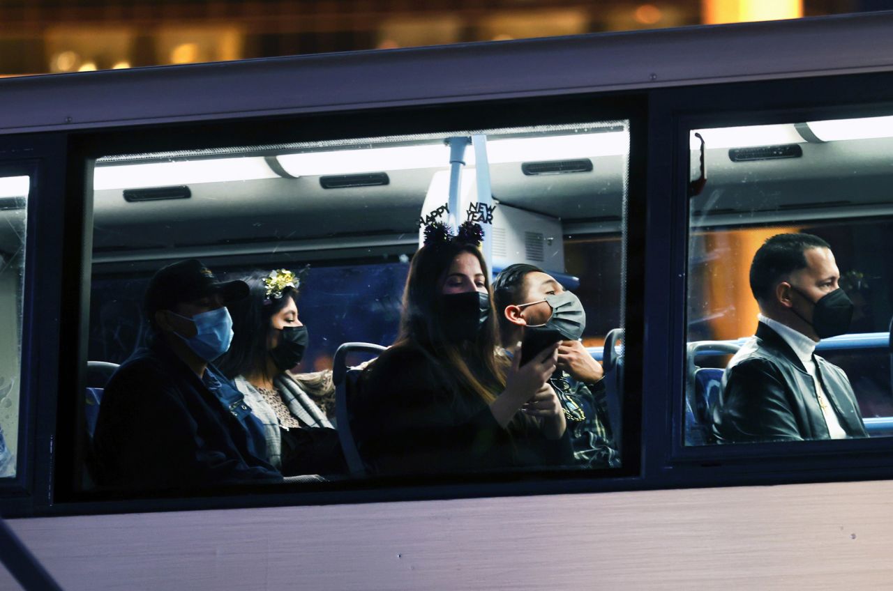 People dressed for New Year's Eve ride a bus in Las Vegas.