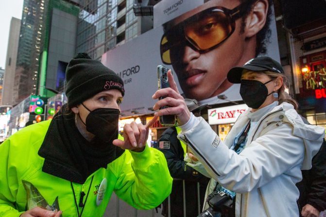 A woman shows proof of vaccination against Covid-19 to enter Times Square for the New Year's Eve ball drop in New York on Friday, December 31.