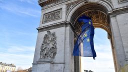 A picture taken on January 1, 2022 shows the European Union flag under the Arc de Triomphe, on the Place de l'Etoile in Paris.