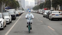 A staff member of a drug store rides a bicycle to deliver medicine in Xi'an, northwest China's Shaanxi Province, Dec. 31, 2021. Xi'an imposed closed-off management for communities and villages on Dec. 23 in an effort to curb the spread of the latest COVID-19 resurgence. (Photo by Tao Ming/Xinhua via Getty Images)