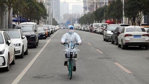 A staff member of a drug store rides a bicycle to deliver medicine in Xi'an, northwest China, Dec. 31, 2021.