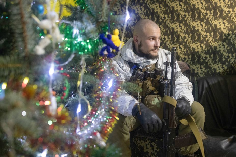 A Ukrainian soldier takes a rest near a fighting position on the line of separation from pro-Russian rebels in the Donetsk region of Ukraine on December 31, 2021.