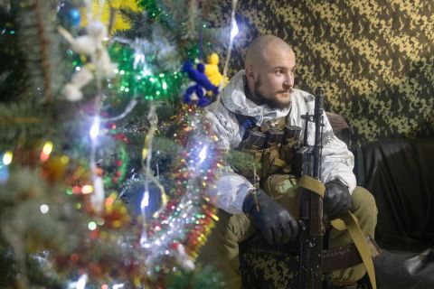 A Ukrainian soldier takes a rest near a fighting position on the line of separation from pro-Russian rebels in the Donetsk region of Ukraine on December 31, 2021.