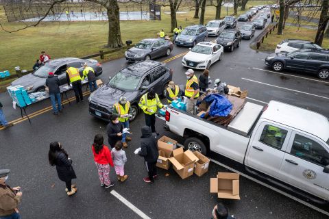 People receive free at-home Covid-19 test kits at a distribution site on January 2, 2022 in Stamford, Connecticut.