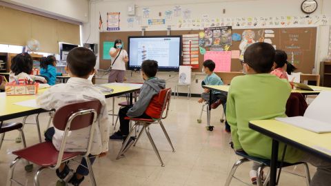 Melissa Wong teaches at a public school in New York last September as mask-wearing children look on. 