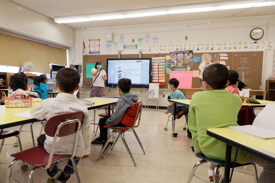A trusted adult whom a child feels close to can help supplement a parent or caregiver's efforts to support their well-being. Teacher Melissa Wong instructs students at New York City's Yung Wing School P.S. 124, September 27, 2021.