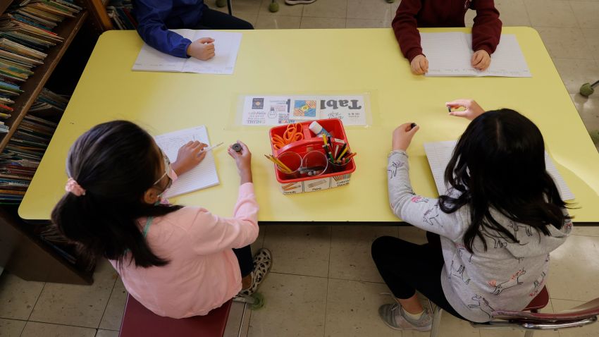 NEW YORK, NEW YORK - SEPTEMBER 27: Masked students participate in a lesson in their classroom at Yung Wing School P.S. 124 on September 27, 2021 in New York City. New York City schools fully reopened earlier this month with all in-person classrooms and mandatory masks on students. The city's mandate ordering all New York City school staff to be vaccinated by midnight today was delayed again after a federal appeals court issued a temporary injunction three days before the mayor's deadline. (Photo by Michael Loccisano/Getty Images)