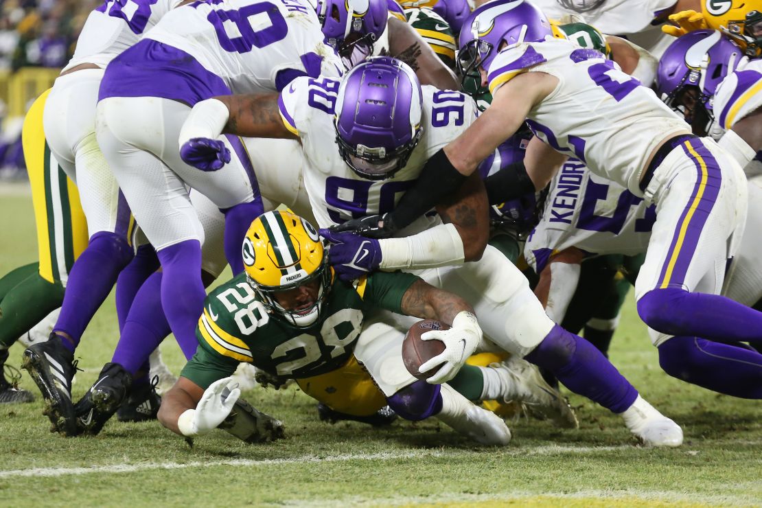 AJ Dillon scores a touchdown underneath the Vikings defense.