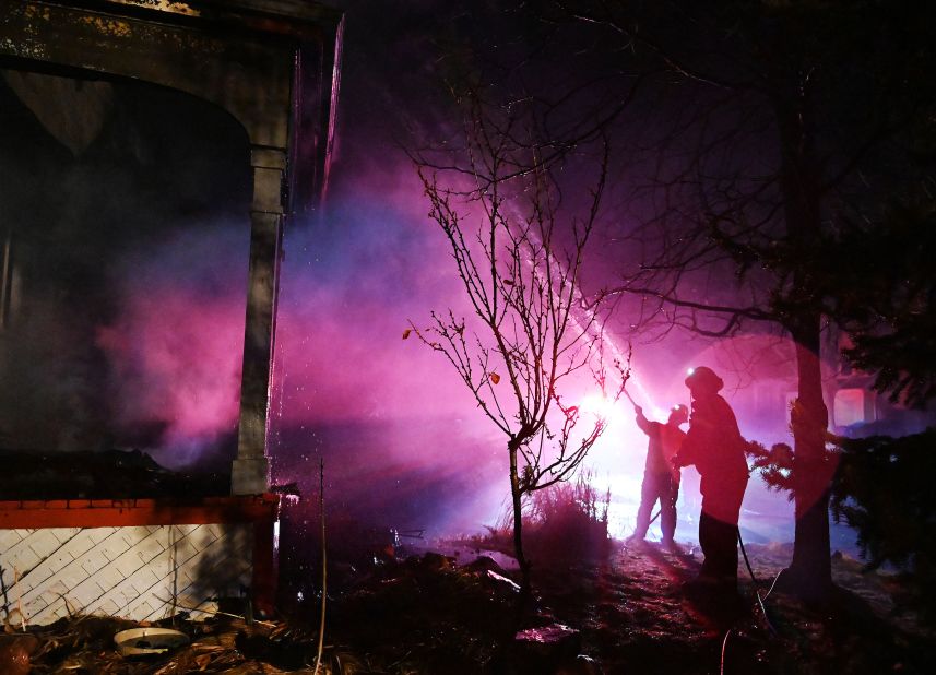 A fire crew works to put out flames at a home in Louisville on December 31.