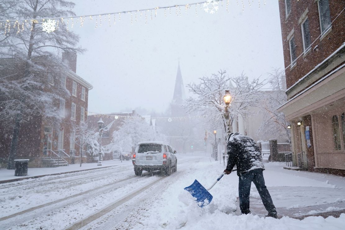 A man in Annapolis, Maryland, shovels now off a sidewalk on Monday.