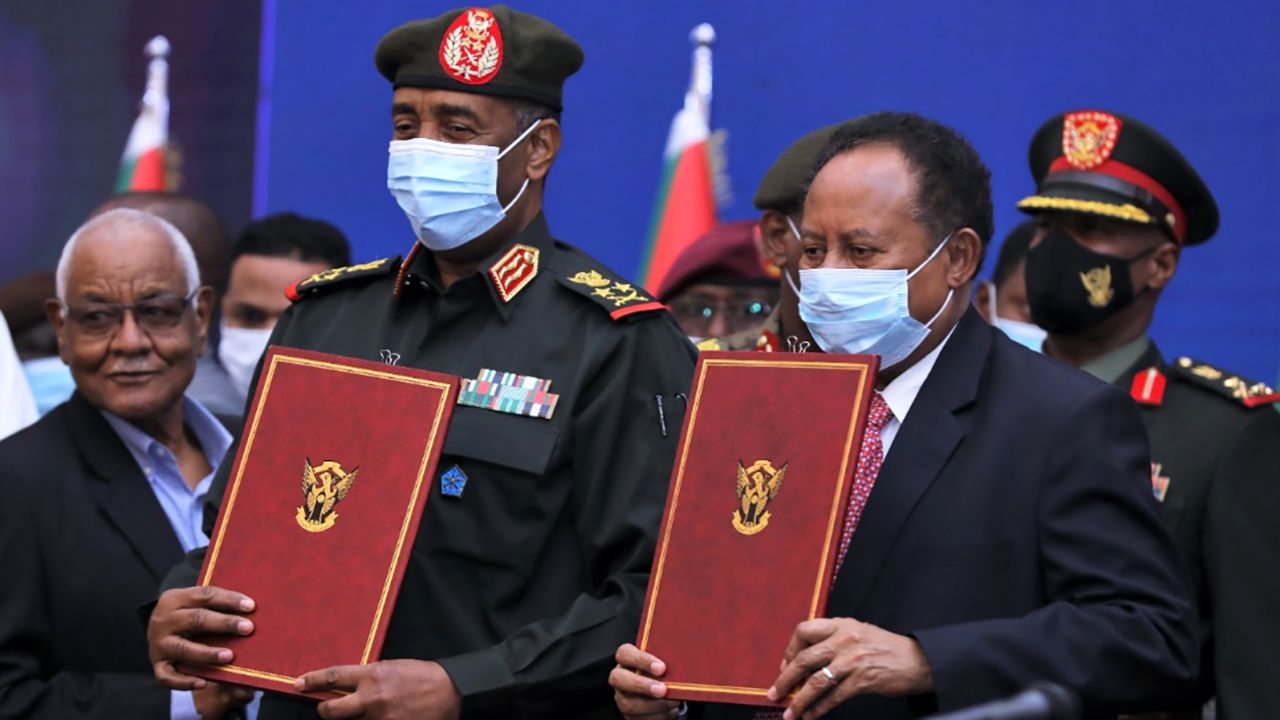 Gen. Abdel Fattah al-Burhan and Prime Minister Abdalla Hamdok sign the political agreement in Khartoum on November 21, 2021. 