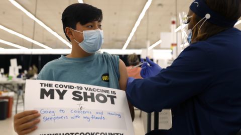 Lucas Kittikamron-Mora, 13 receives his first Pfizer vaccination at the Cook County Public Health Department, May 13, 2021 in Des Plaines, Ill.