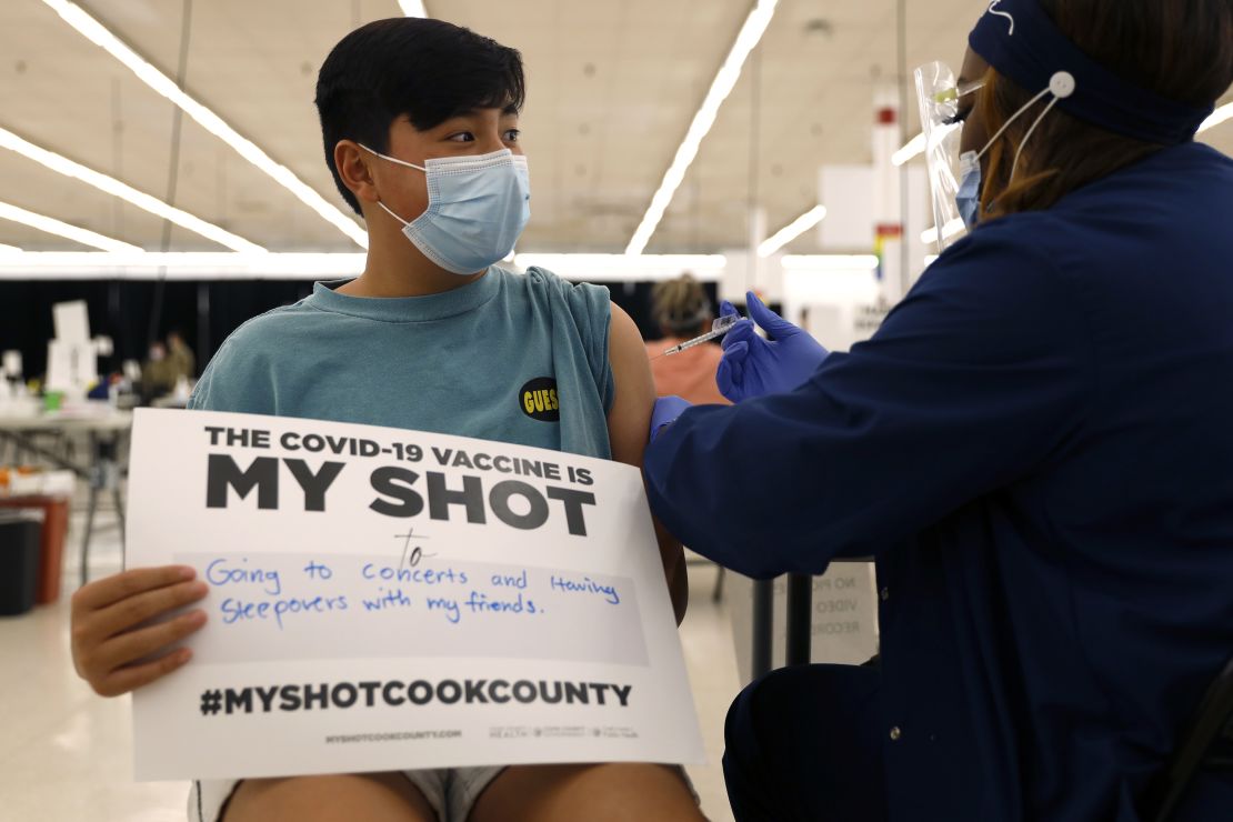 Lucas Kittikamron-Mora, 13 receives his first Pfizer vaccination at the Cook County Public Health Department, May 13, 2021 in Des Plaines, Ill.