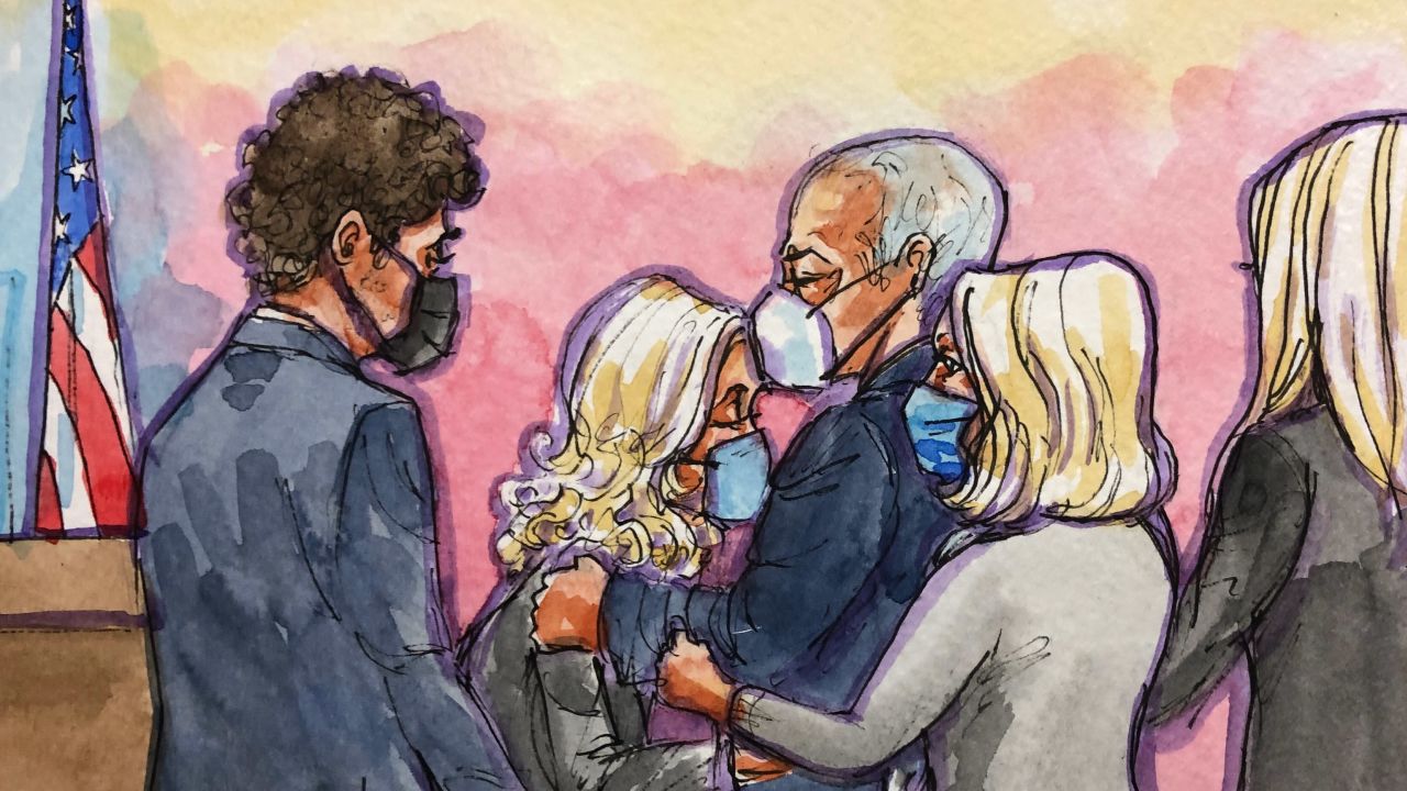 Elizabeth Holmes is kissed on her head by her father in federal court in San Jose, California, on January 3, 2022.