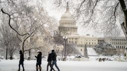 People walk along a snow covered Capitol Hill on Monday, Jan. 3, 2022 in Washington, DC. A winter storm warning for the District and adjacent counties until Monday afternoon. 