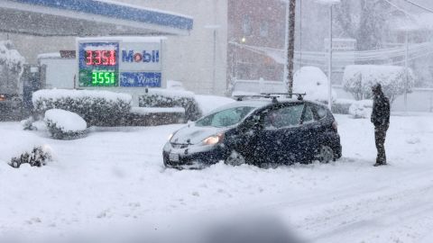 A car is stuck in the snow in Alexandria, Virginia, as a winter snow storm hits the northern part of the state Monday. 