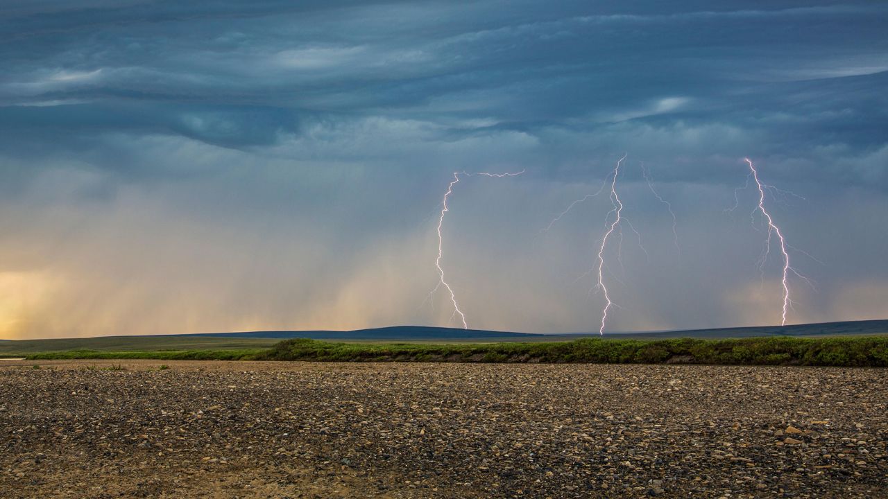Lightning bolts descend from dark clouds in northern Alaska. Lightning tracker Vaisala reported a significant uptick in far-northern Arctic lightning in 2021.