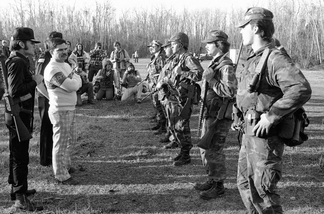 Louis Beam, Grand Dragon of the Texas Realm of the Knights of the Ku Klux Klan, between two body guards on Feb. 14, 1981, in Santa Fe, Texas.