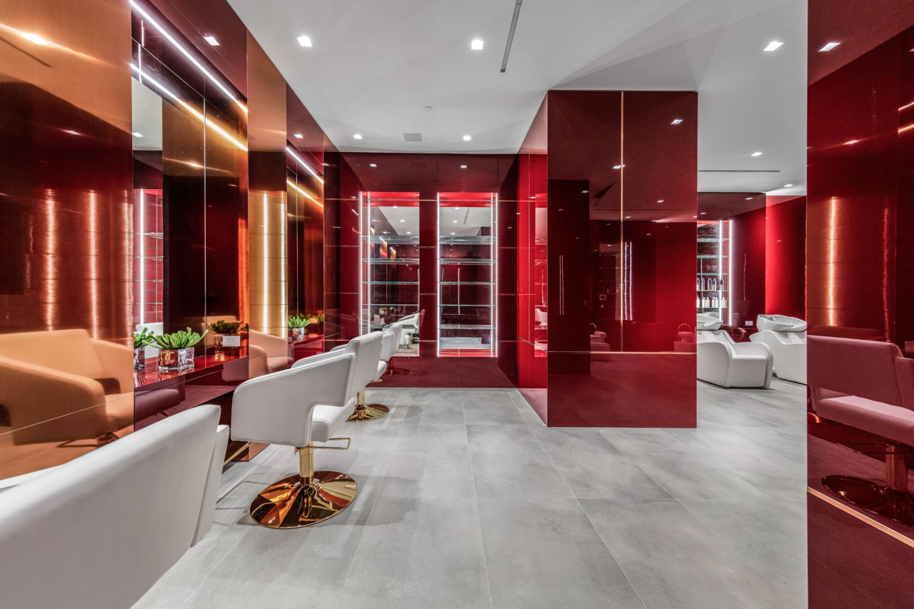 Amenities include a salon, spa, nightclub, running track, movie theater, and five pools, including an infinity-edged moat.