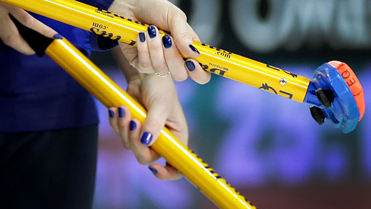 Sweden's Margaretha Sigfridsson (left) and Maria Prytz hold onto their brooms during the women's curling semifinal against Switzerland at the 2014 Winter Olympics.