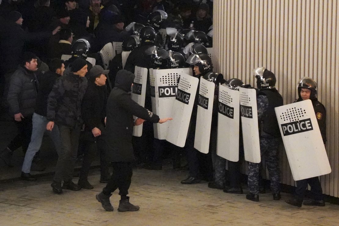 Protesters and riot police in Almaty on Wednesday.