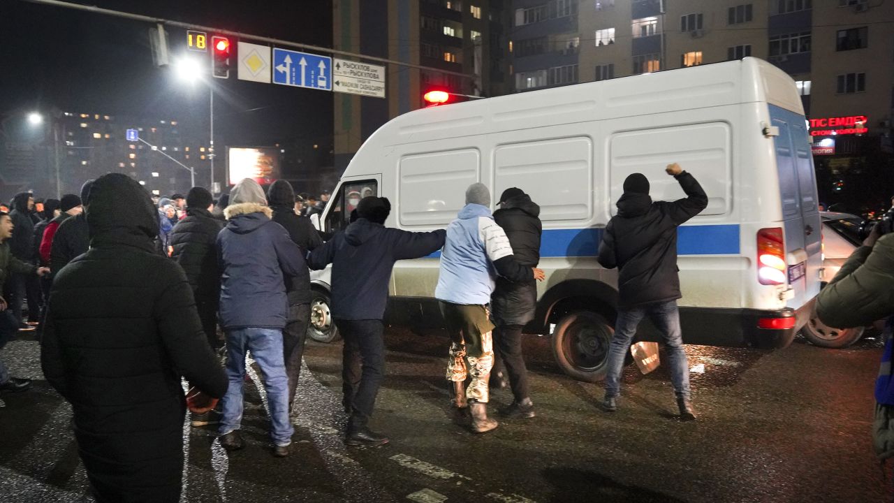 Demonstrators try to block a police bus during a protest in Almaty, Kazakhstan on January 4, 2022.