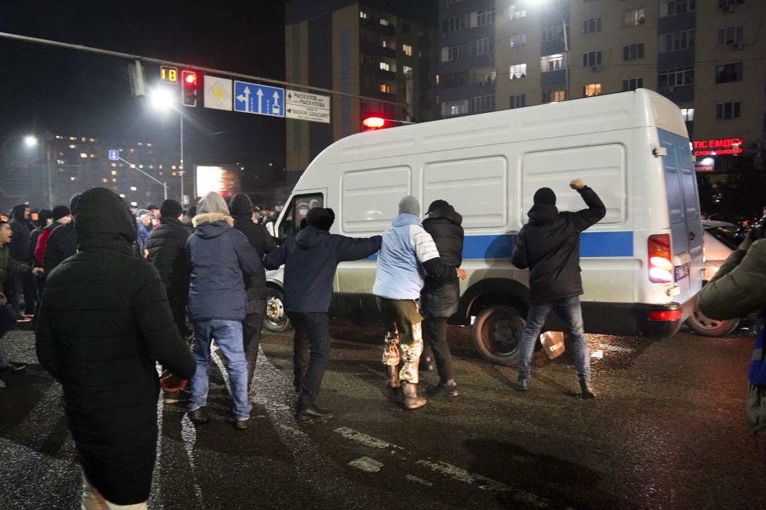 Demonstrators try to block a police bus during a protest in Almaty, Kazakhstan on January 4, 2022.