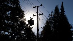 OAKLAND, CA - OCT. 15: PG&E line inspector Kevin Ogans works to clear lines so crews can begin removing a tree that crashed into live power lines along Mountain Boulevard in the Montclair Village neighborhood of Oakland, Calif. Thursday, October 15, 2020. PG&E implemented Public Safety Power Shutoffs to over 53,000 customers across the Bay Area, including homes and businesses in the Montclair Village area of Oakland, due to high winds and a combination of high fire danger. (Jessica Christian/The San Francisco Chronicle via Getty Images)