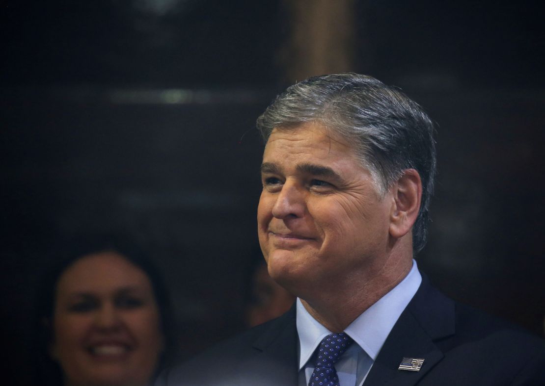 Sean Hannity looks on as President Donald Trump holds a news conference after his summit with North Korean leader Kim Jong Un, February 28, 2019.  