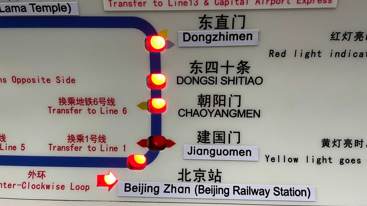 New English names of subway stations have been plastered on a map inside a Beijing subway train.