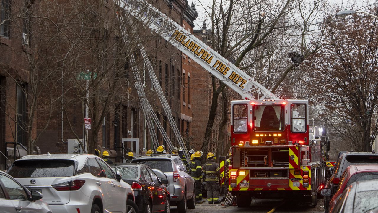 The Philadelphia Fire Department works at the scene of a deadly row house fire in Philadelphia on Wednesday.