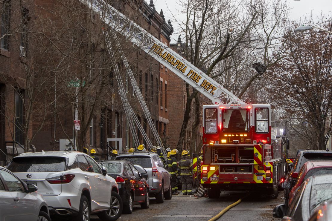 Firefighters from the Philadelphia Fire Department work at the scene of a deadly row house fire in Philadelphia on January 5, 2022. 