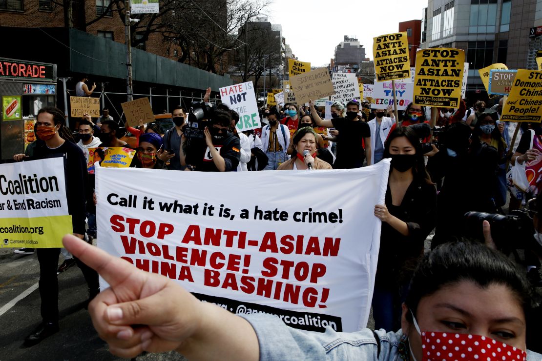 Supporters of the Asian-American community shout slogans during a rally in the Queens borough of New York in March 2021.