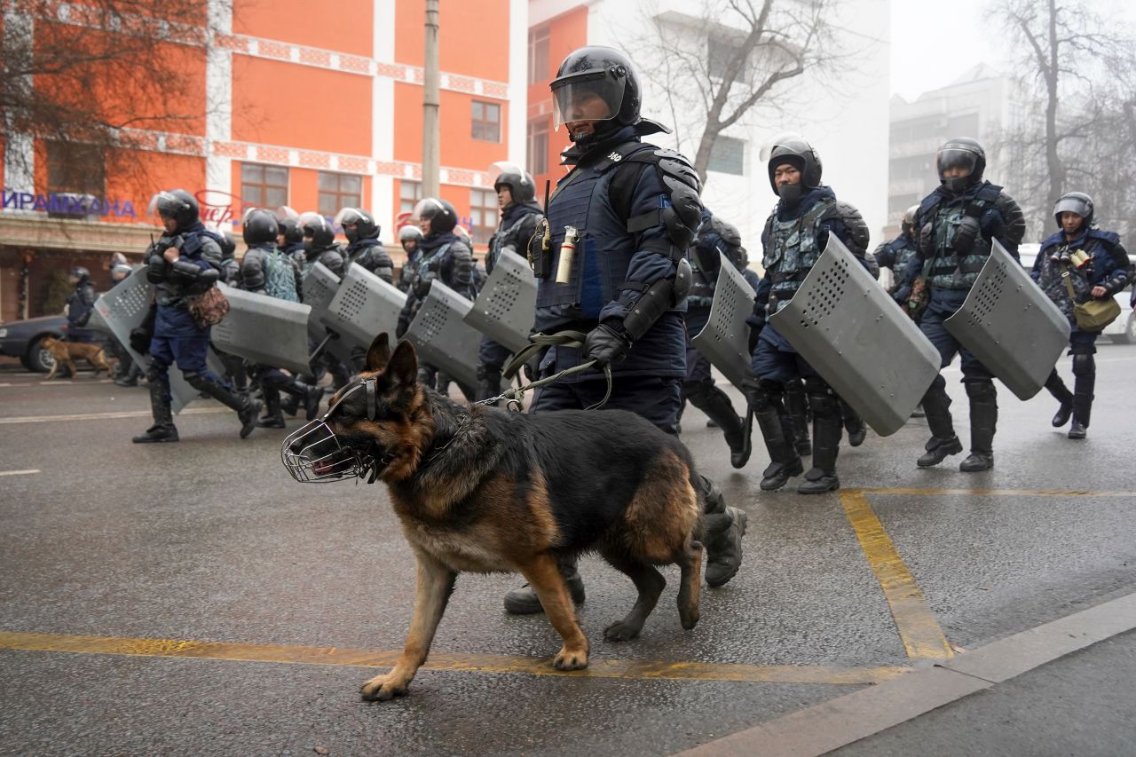 Police move to block demonstrators during a protest in Almaty on January 5.