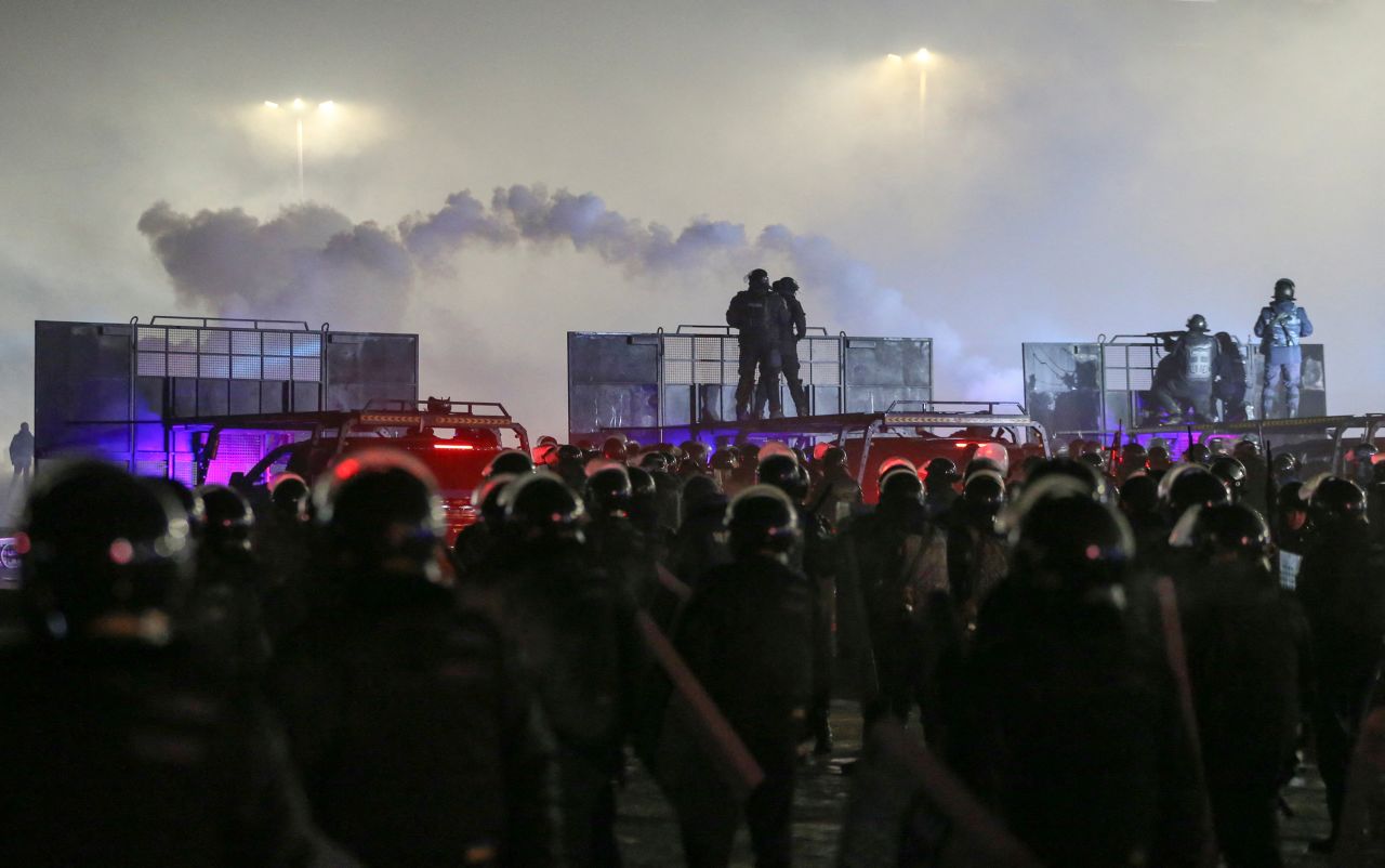 Police officers stand guard during a protest in Almaty on January 4.